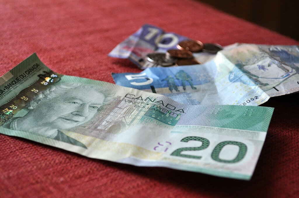 Canadian dollar bills, representing permanent residence application fees