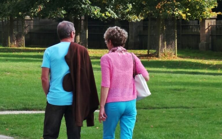 Family walking together in a green park, representing family sponsorship and reunification in Canada